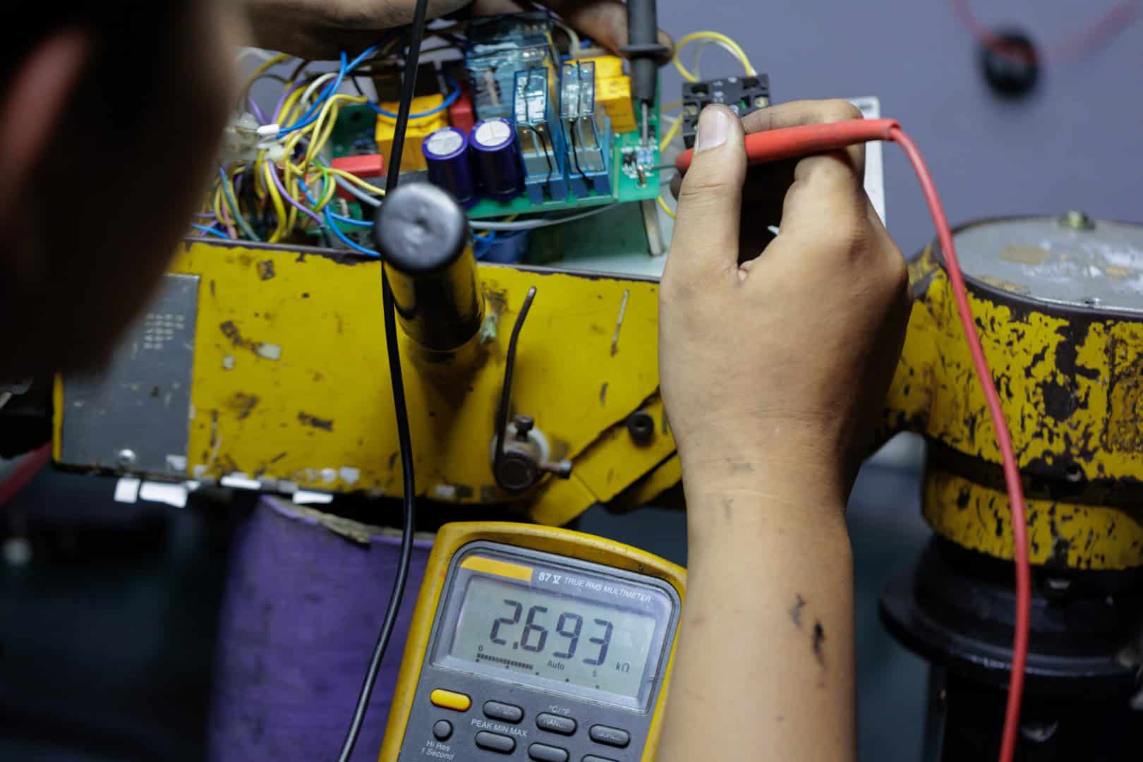 Detailed close-up of hands holding multimeter