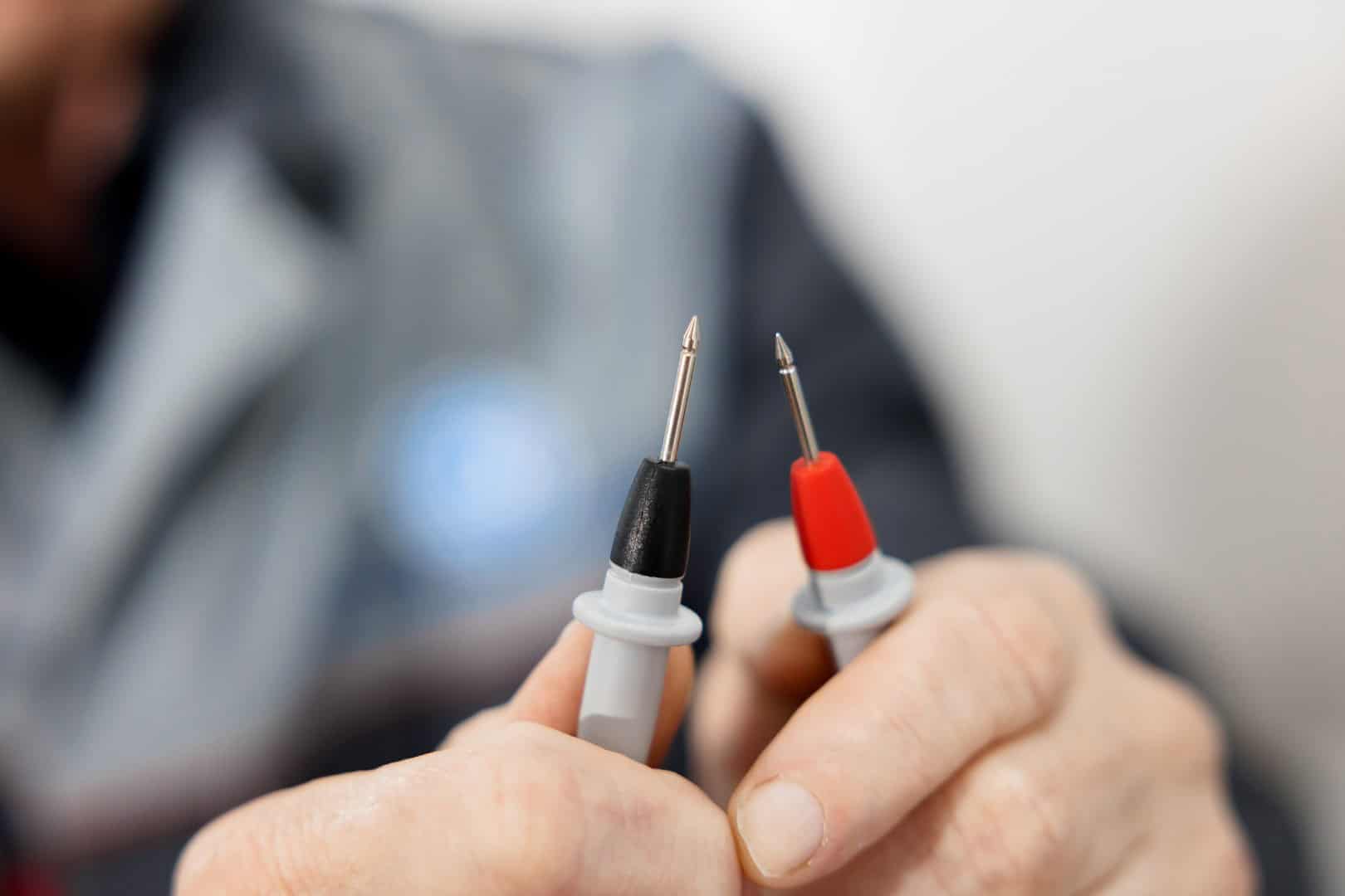 Electrical test leads in the hands of an electrician engineer